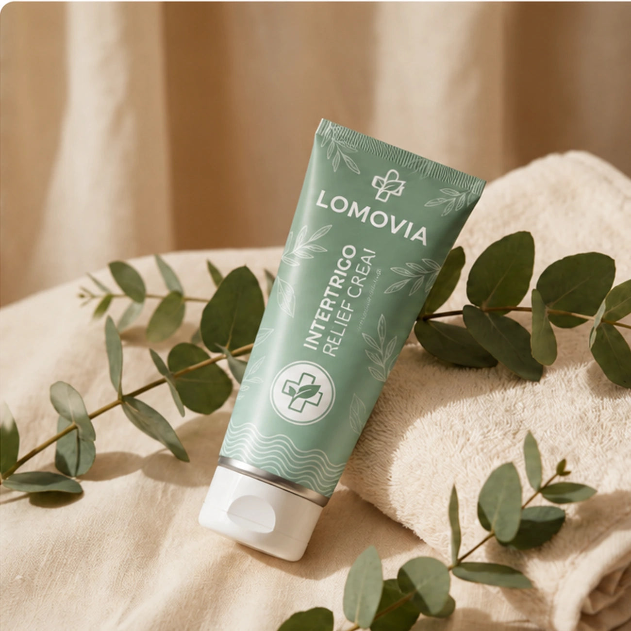 LOMOVIA Intertrigo Relief Cream tube with folded cream towel and botanical leaves